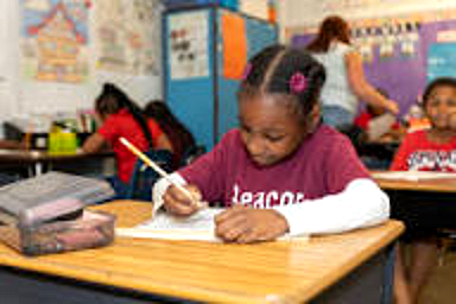 A Beacon student writing during independent work time