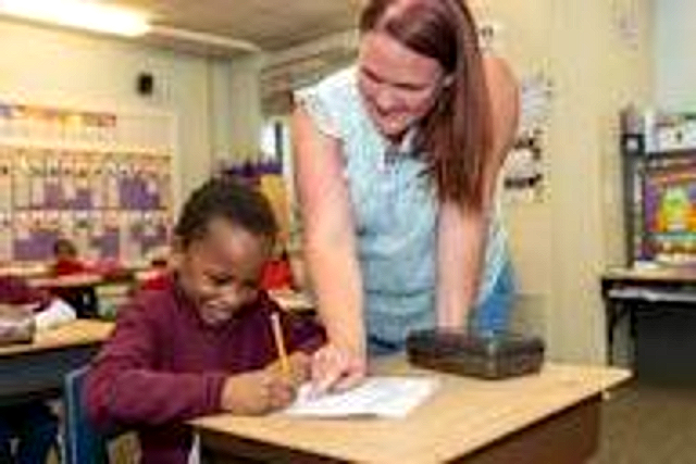 A Beacon teacher working one-on-one with a student