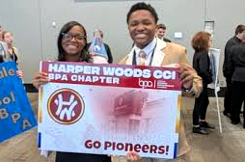 Students holding the Harper Woods CCI BPA Chapter Go Pioneers banner