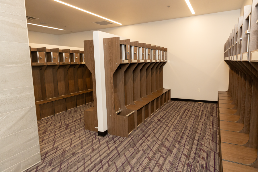 A second locker room with wood lockers and patterned carpet