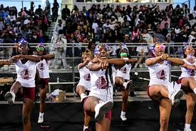 The Harper Woods cheer team performing at a football game