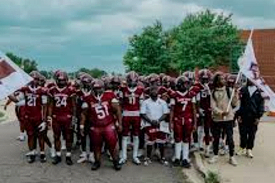 The Harper Woods team walking out to the field with flags