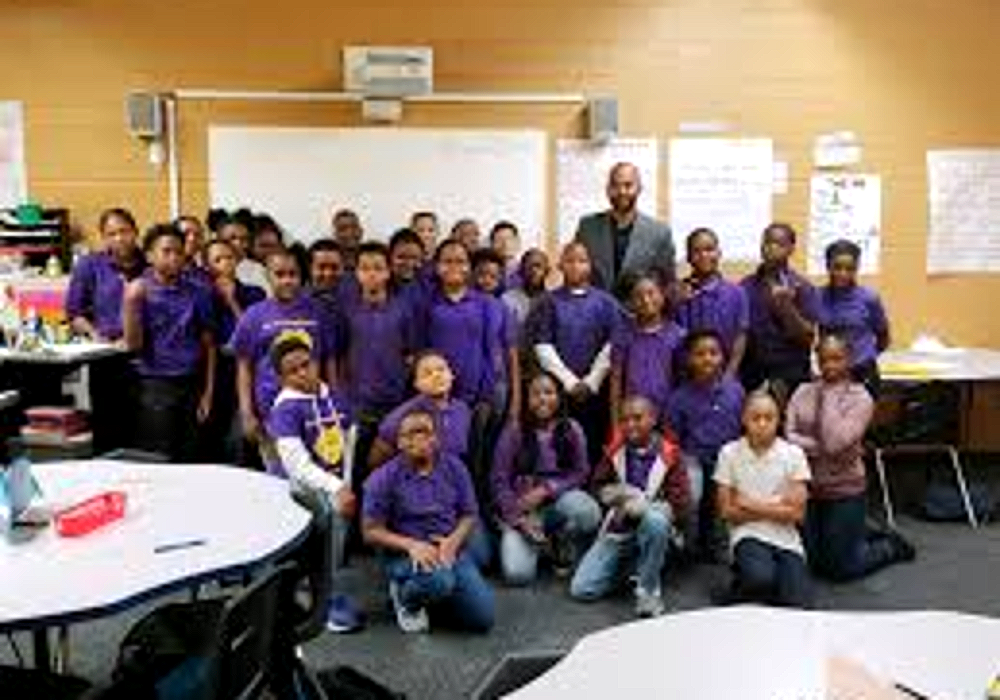 A Harper Woods Middle School class photo with their teacher