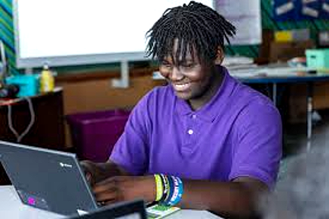 A Harper Woods Middle School student working at his laptop