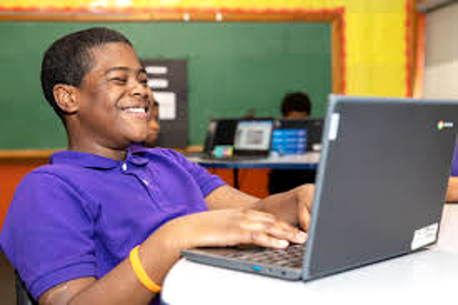 A Harper Woods Middle School teacher working with a small group of students