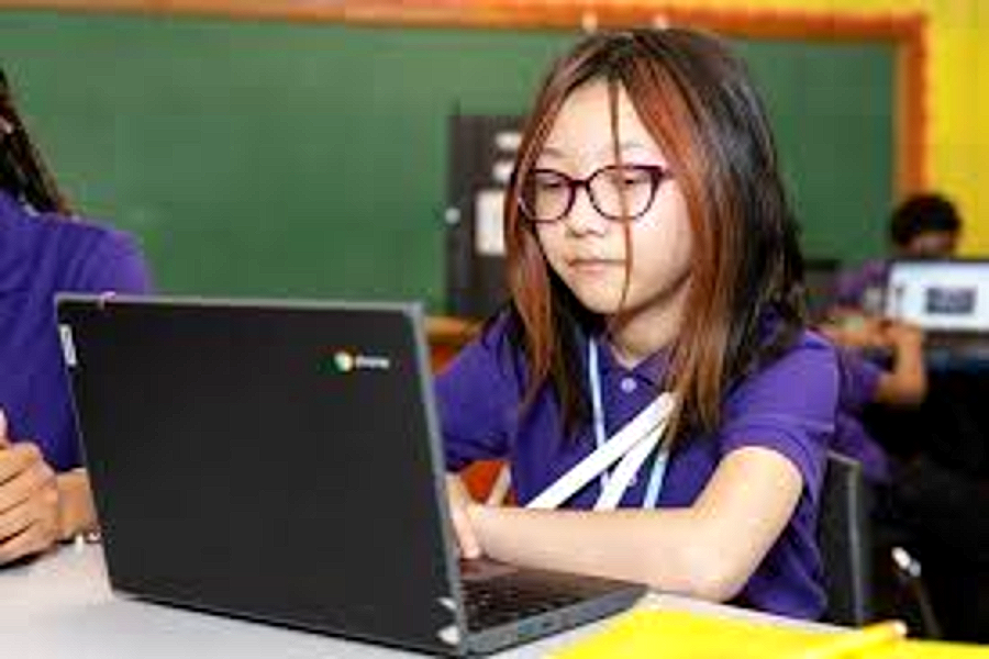 A Harper Woods Middle School student focused on her laptop