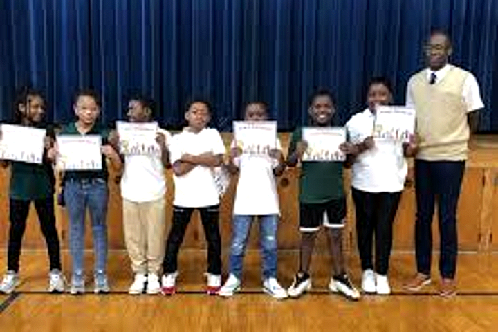 Tyrone students holding achievement certificates in the gym